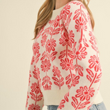 Woman wearing a floral pattern knit sweater on a beige background